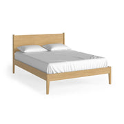 Natural Oak bed frame with white mattress and pillows on a white background