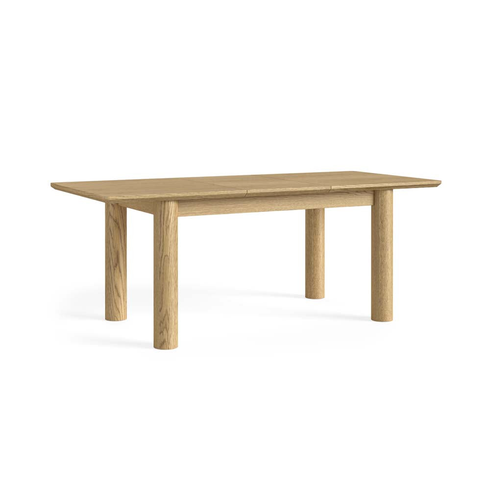 A light oak wood extendable dining table with a rectangular top and four cylindrical legs, shown on a solid white background.