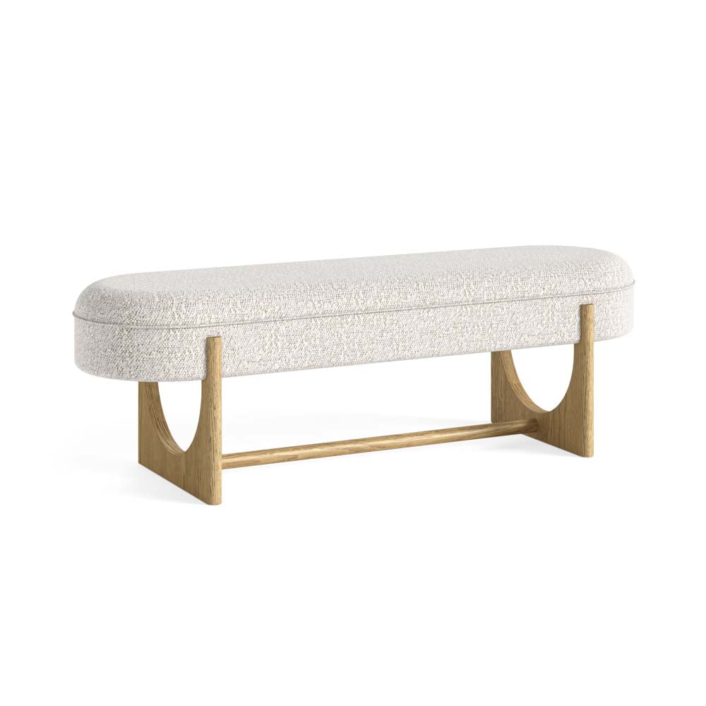 White upholstered bouclé fabric dining bench with wooden cut out legs on a white background