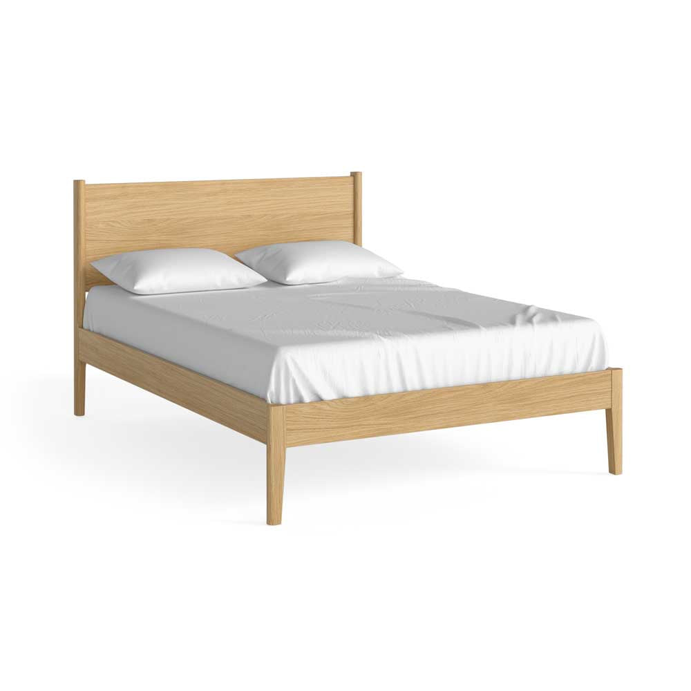 Natural Oak Wooden bed frame with white bedding on a white background