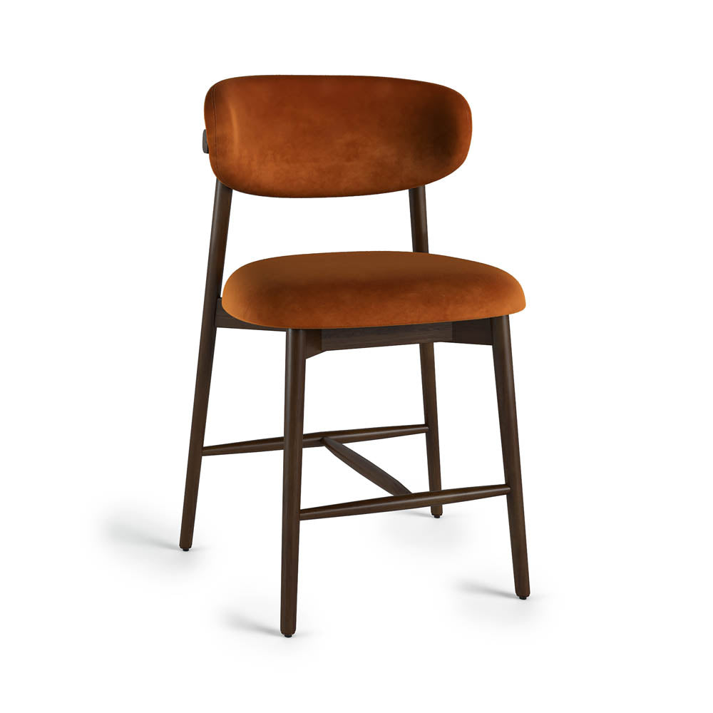 Rustic orange velvet cushioned bar stool on a white background