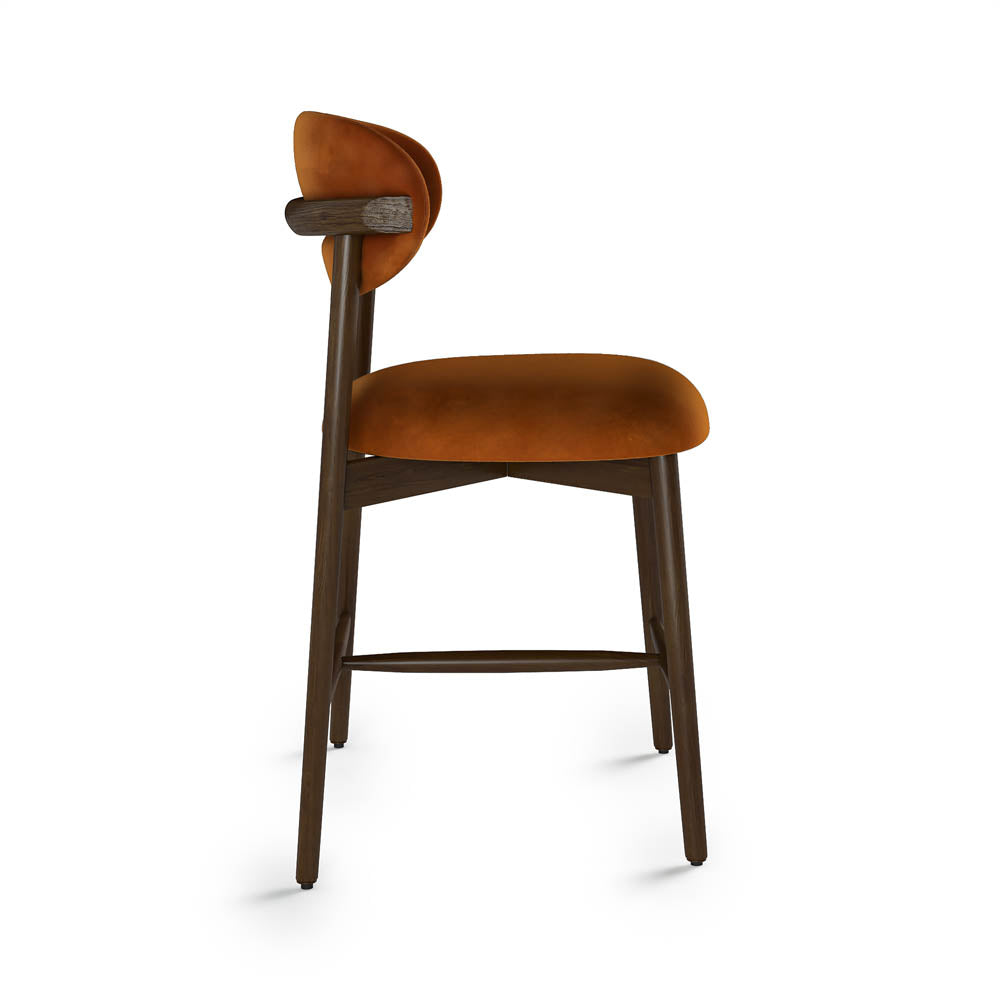 Rustic orange velvet cushioned bar stool on a white background