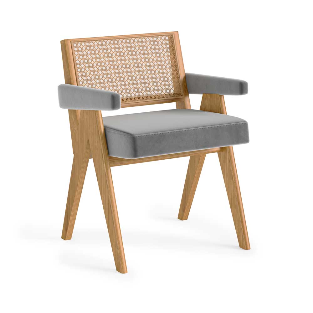 A modern wooden armchair with a grey velvet upholstered seat and arms, and a woven cane backrest, shown on a white background.