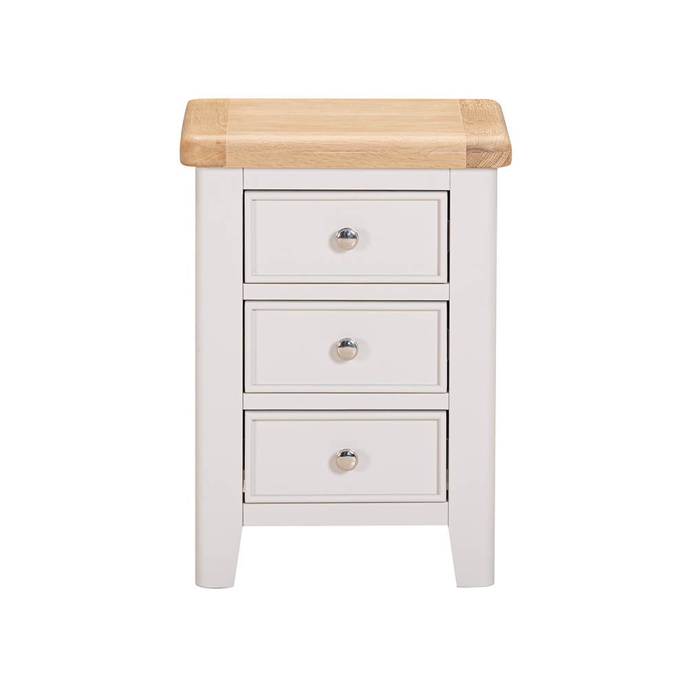 White bedside table with three drawers and a wooden top on a white background