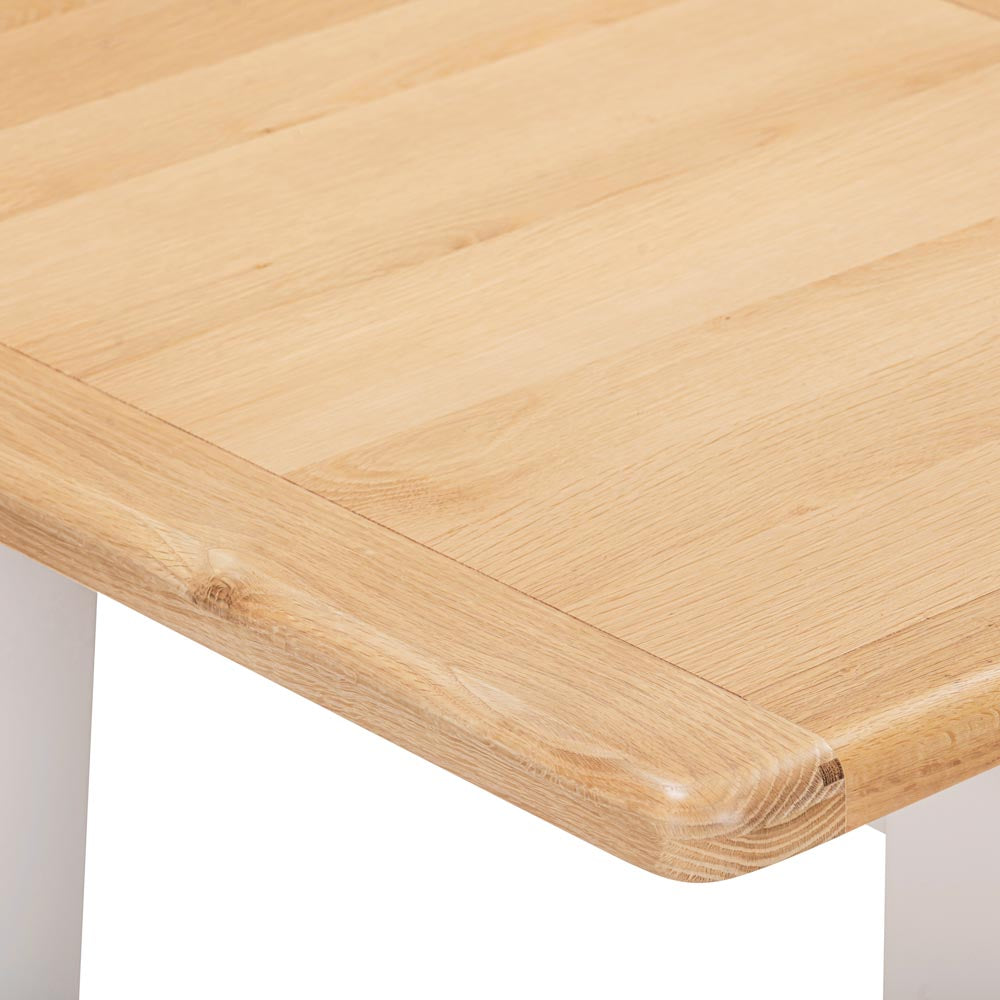 Close-up of a wooden table corner with a white background