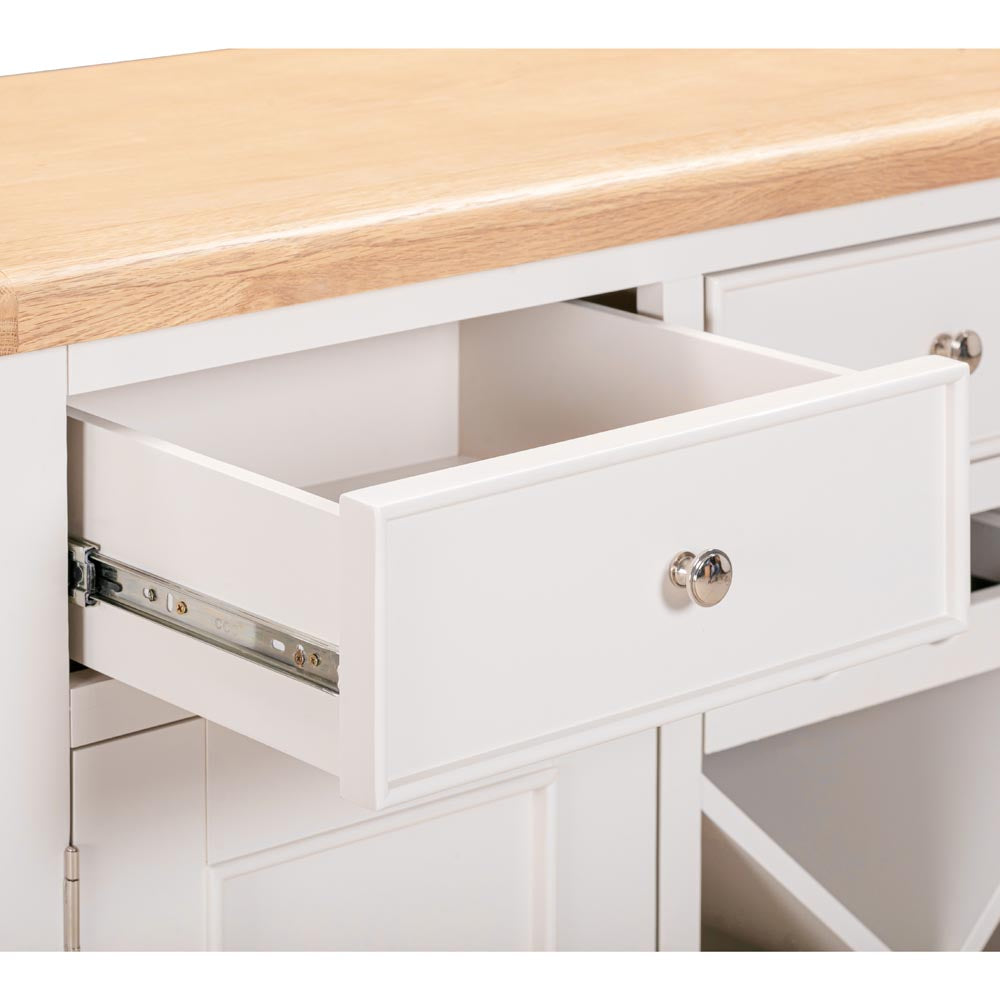Light grey-beige  kitchen sideboard with a wooden countertop and open drawer