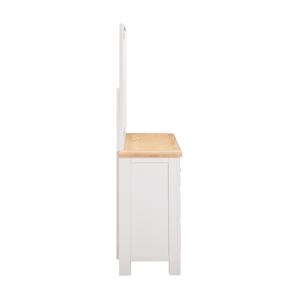 Side view of a light grey-beige chest of drawers with a wooden countertop on a white background
