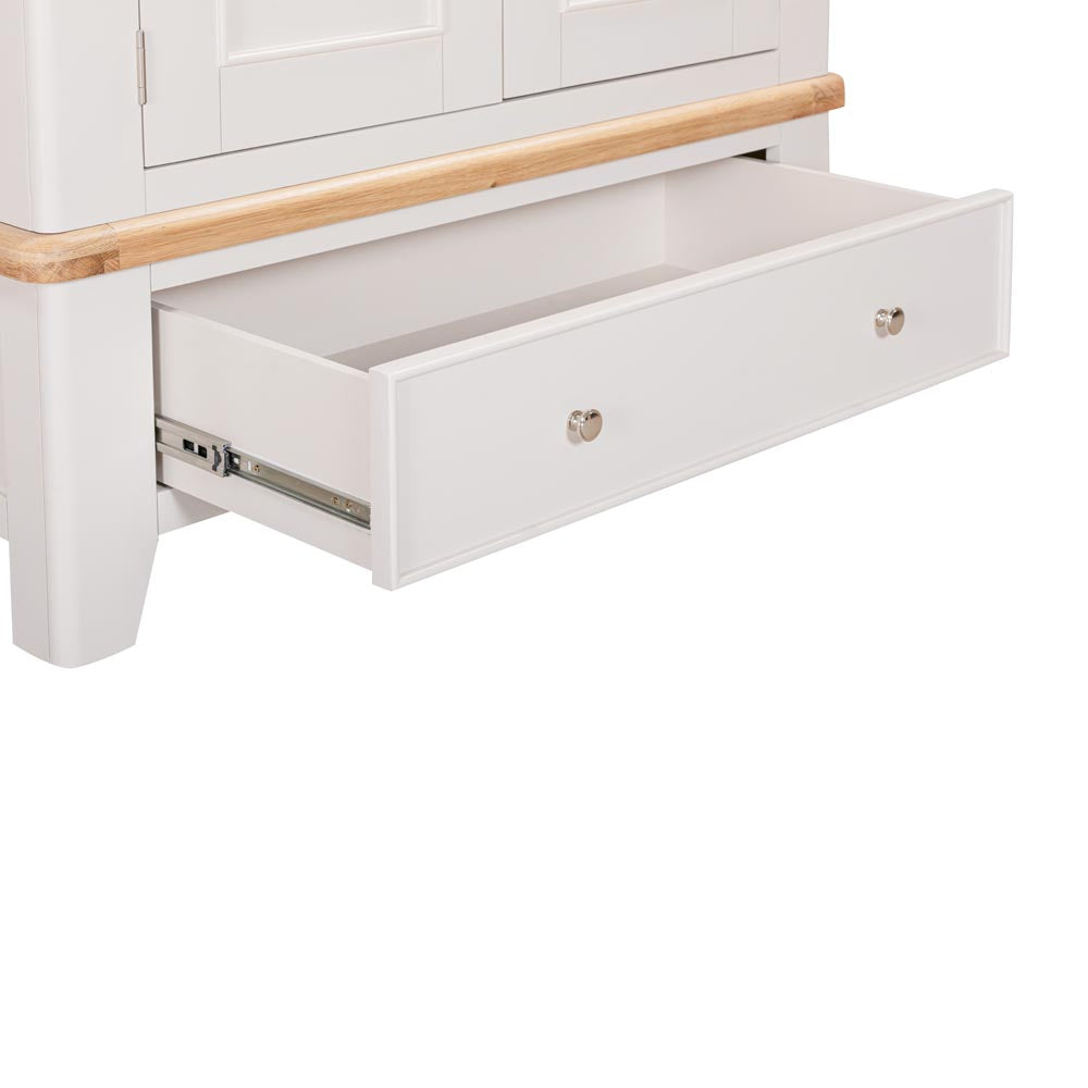 Light grey-beige wardrobe with a wooden top and open drawer on a white background
