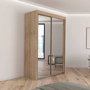 1.5 metre oak wardrobe with mirrored sliding doors in a white bedroom.