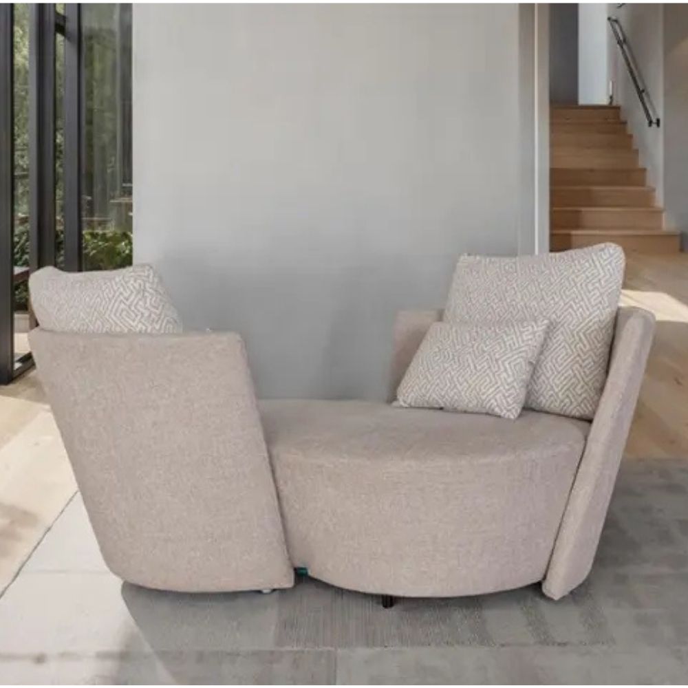 Beige infinity sofa with patterned cushions in a modern interior setting