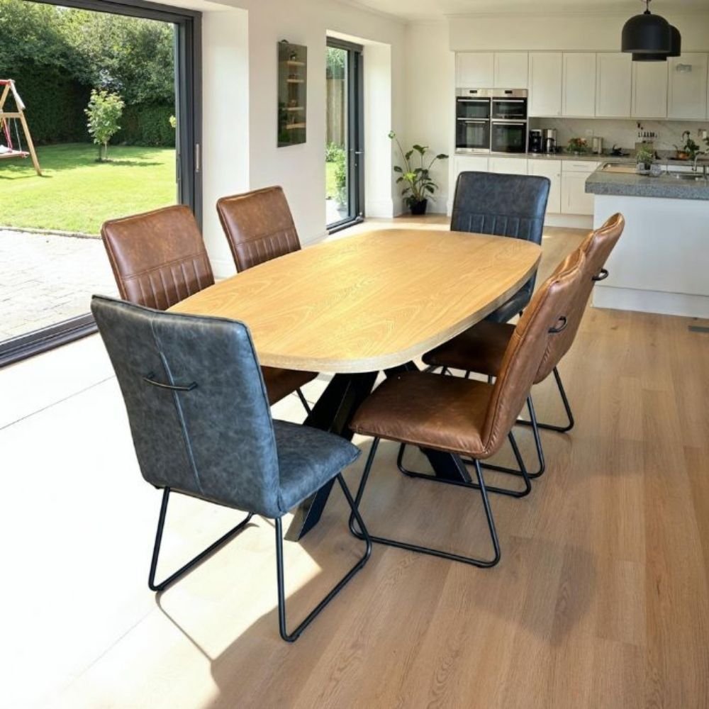 Dining area with a wooden table and chairs in a modern kitchen.