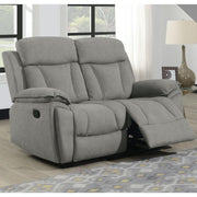 Gray 2 seater recliner chair in a living room setting with a lamp and window in the background.