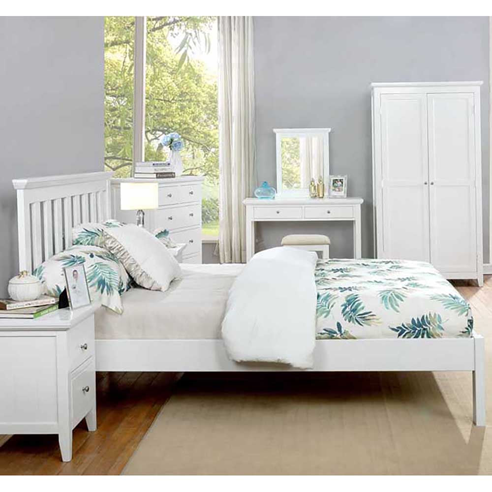 White bedroom furniture set with tropical-themed bedding