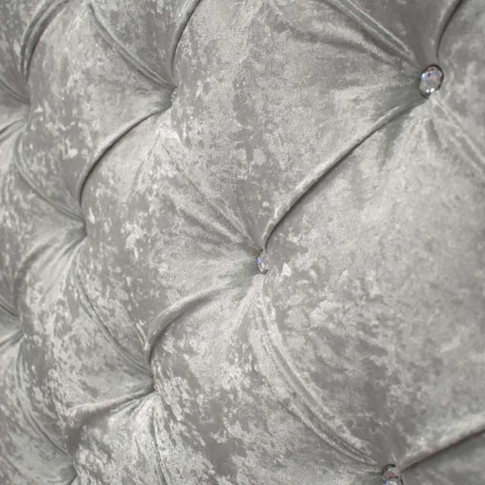 Close-up of a textured gray headboard with button details