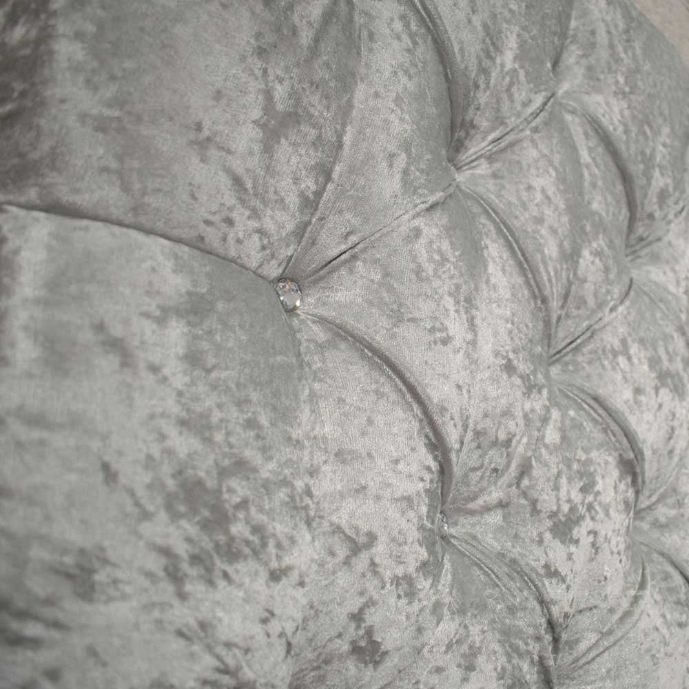 Close-up of a textured gray headboard with tufted design