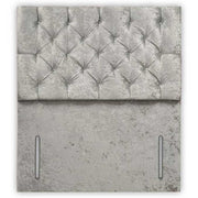 Gray tufted headboard with concrete-like base on a white background
