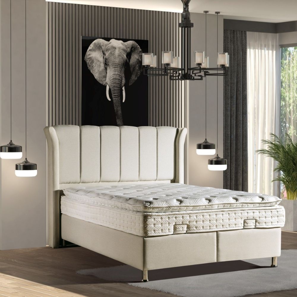 Beige bed with white mattress in a modern bedroom setting, featuring a large elephant painting on the wall.