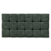 Green tufted headboard on a white background