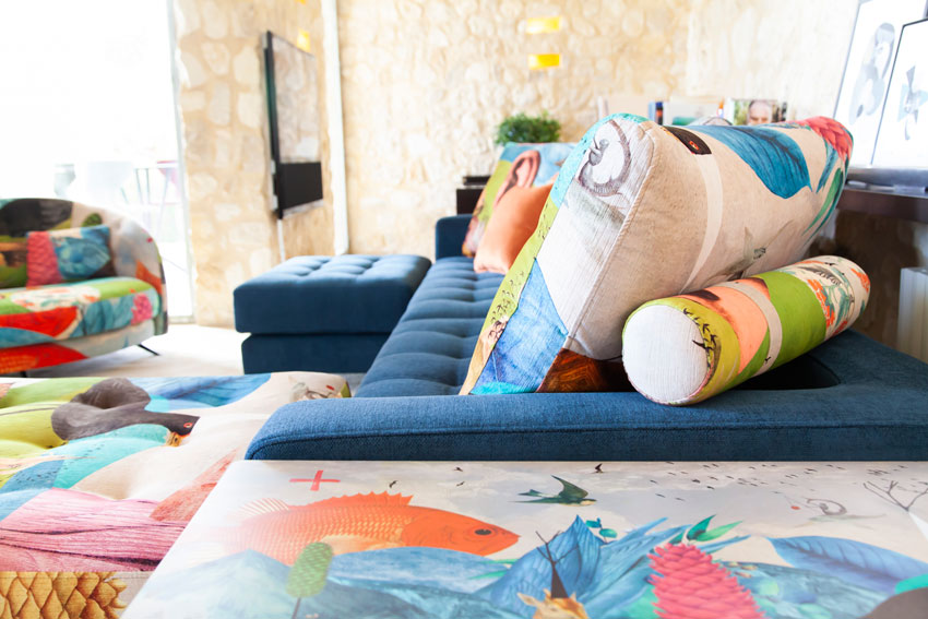 Manacor sofa by Fama in Navy blue Fabric with clear angle of backrest and roller.