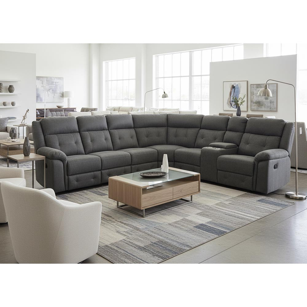 Gray sectional sofa in a modern living room with a coffee table and chairs.