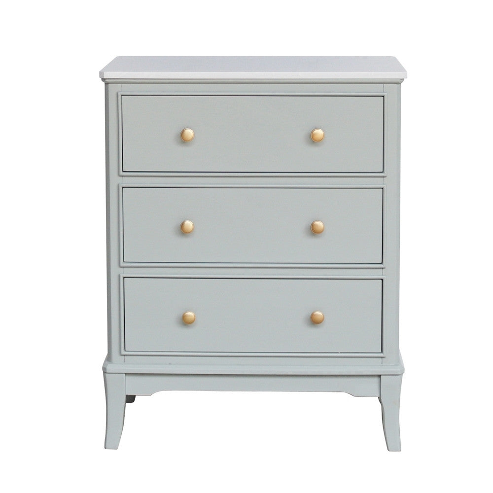 Sage green three drawer dresser with gold knobs on a white background