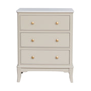 Beige / stone coloured 3 drawer dresser with gold knobs on a white background