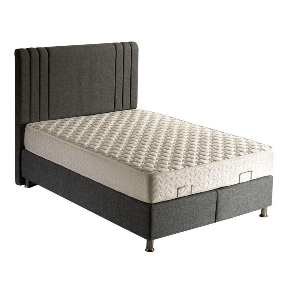 Gray upholstered ottoman divan bed frame with a mattress on a white background
