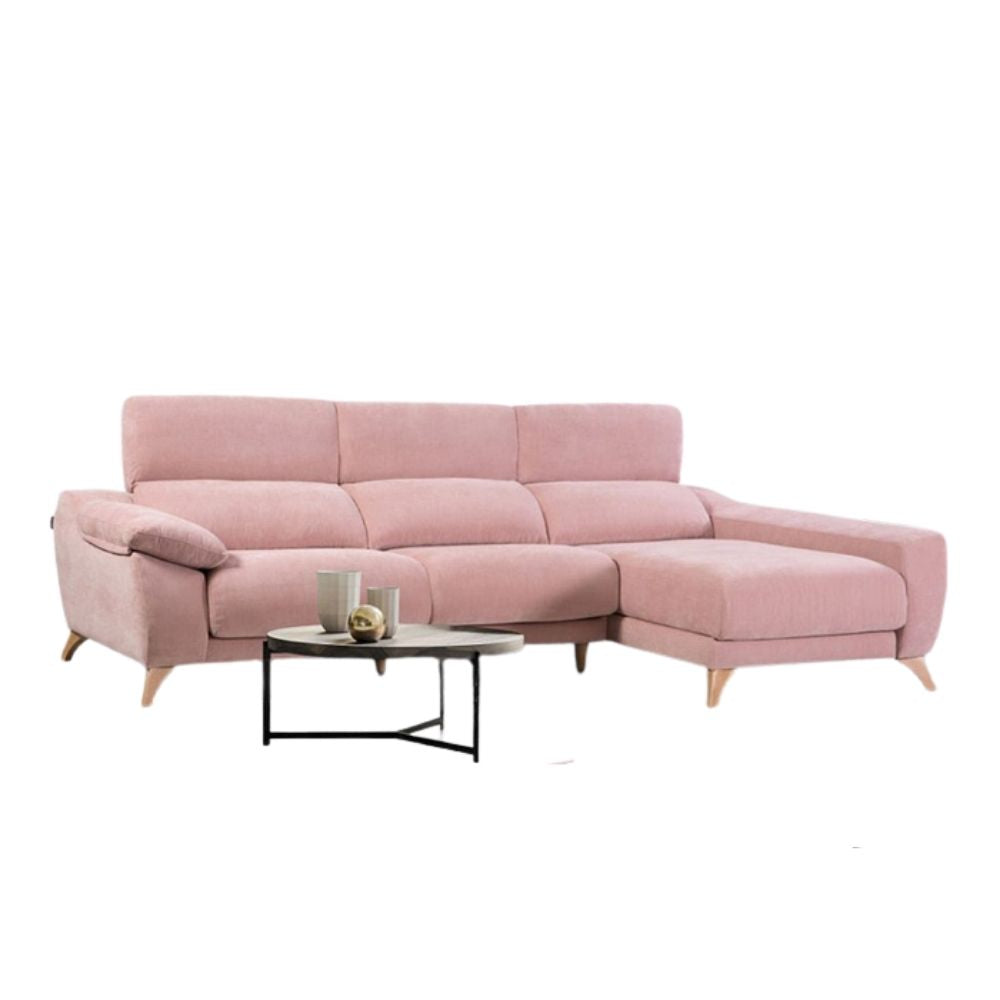 Pink sectional sofa with a small table on a white background