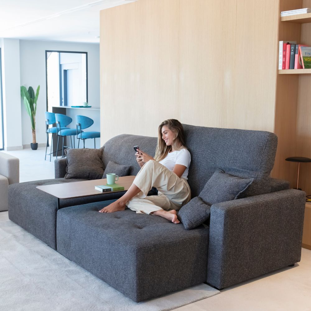 Paradis sofa with seats extended and coffee table between seats.