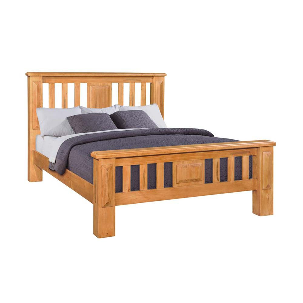 Pine bed with slatted headboard and footboard and bedding on a white background