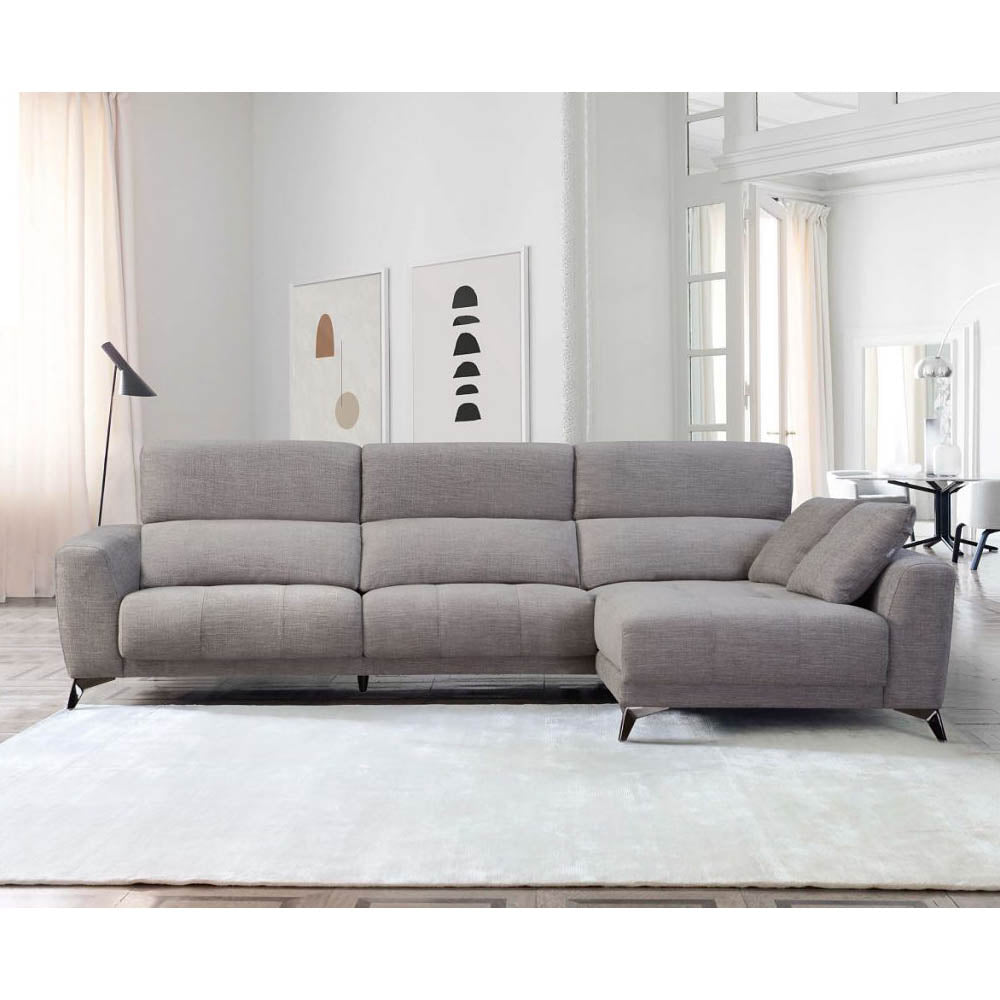 Gray sectional sofa in a modern living room with white walls and light wood flooring.