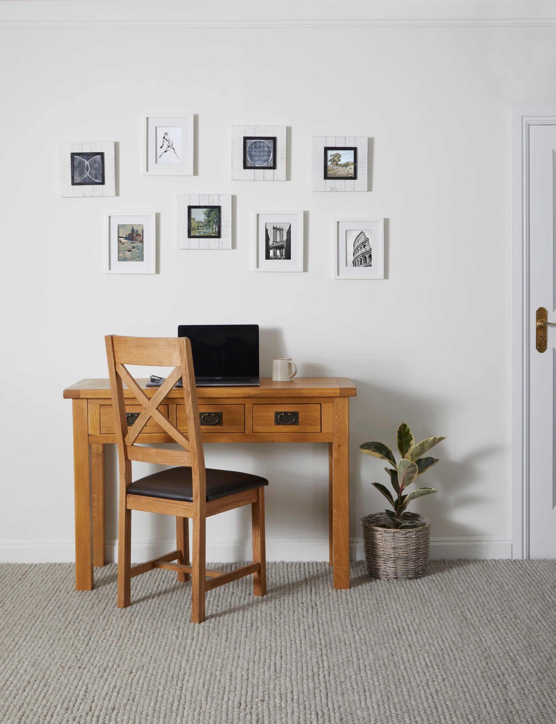 lifestyle image of a single cross back chair positioned in front of a desk with 3 drawers.