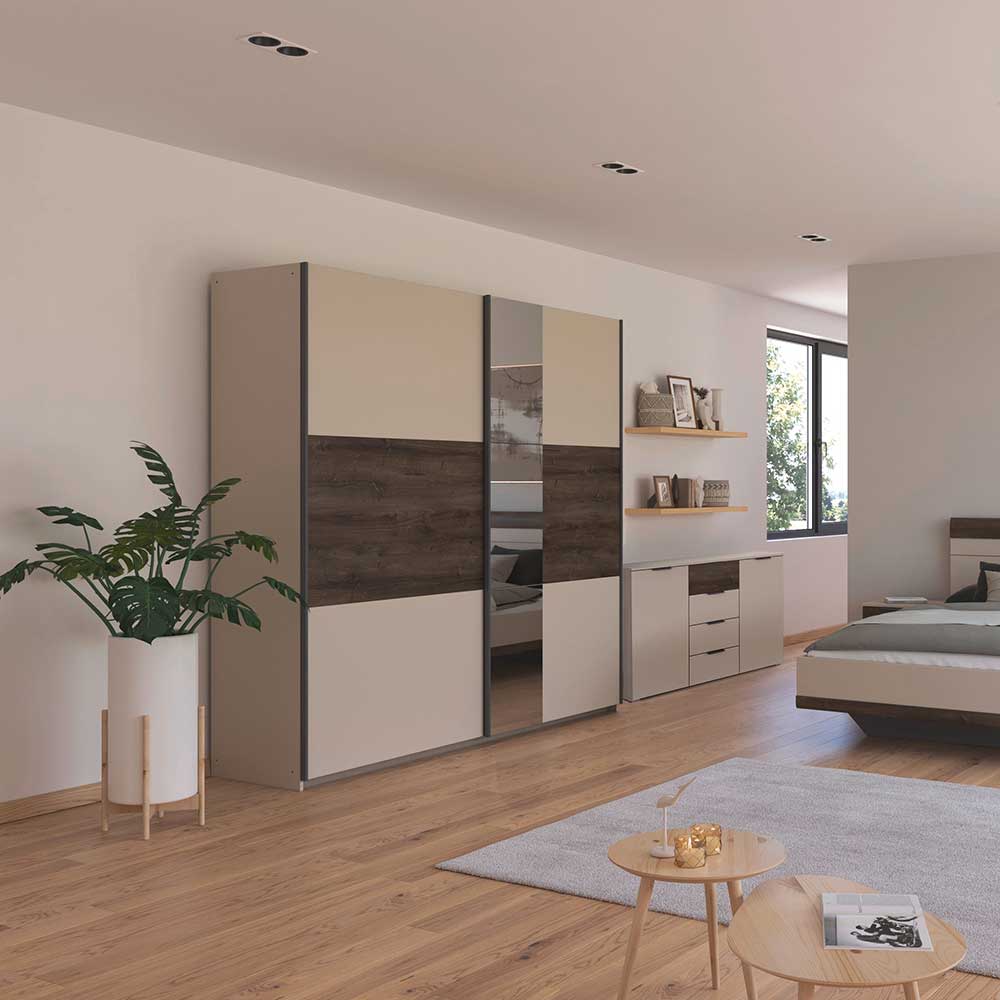 Modern bedroom with a large sliding wardrobe, bed, and decor elements.