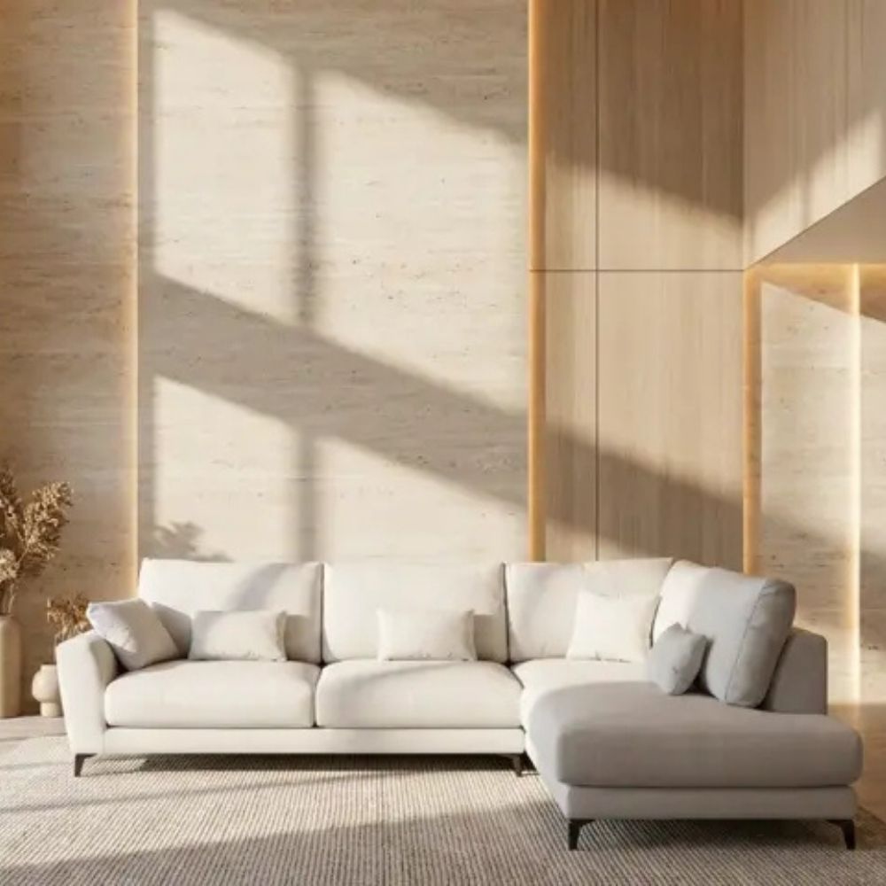 Modern light gray sectional Fama sofa in a room with wooden walls and a rug.