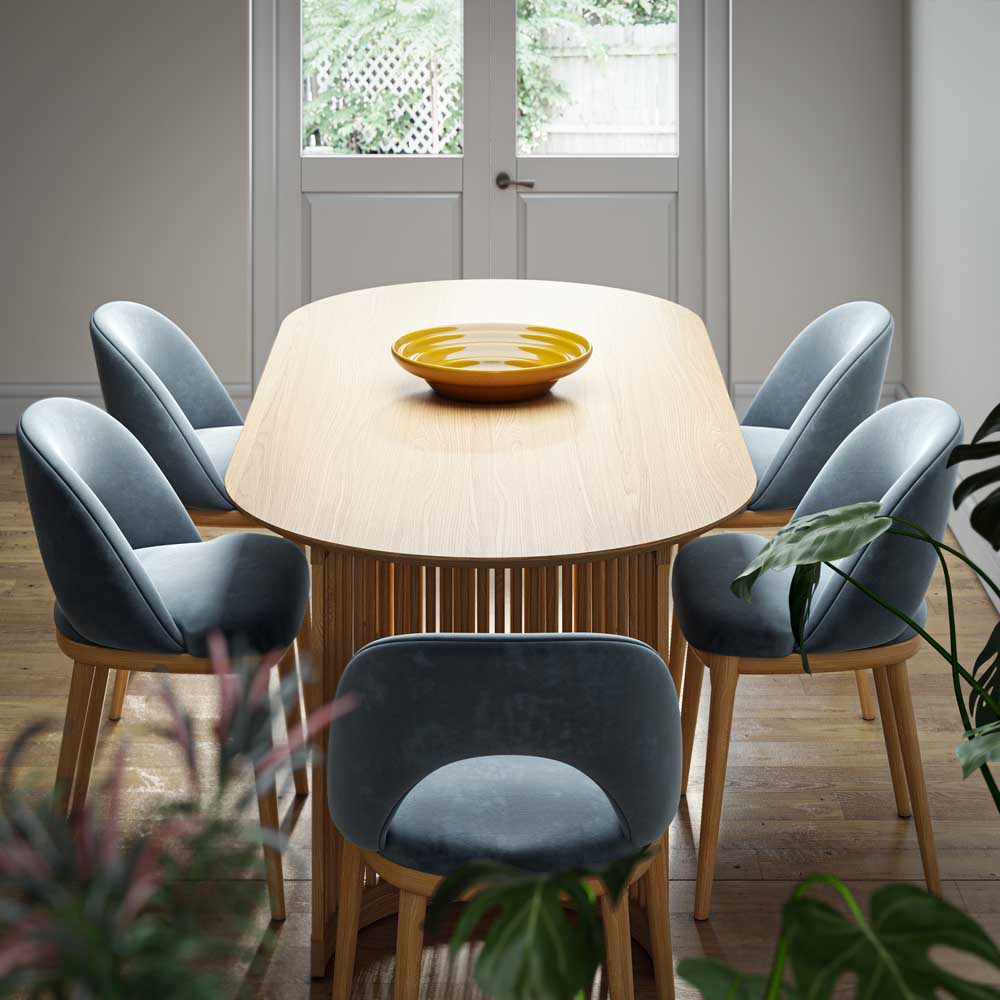 Dining room with a wooden table and blue chairs, featuring a yellow bowl on the table.
