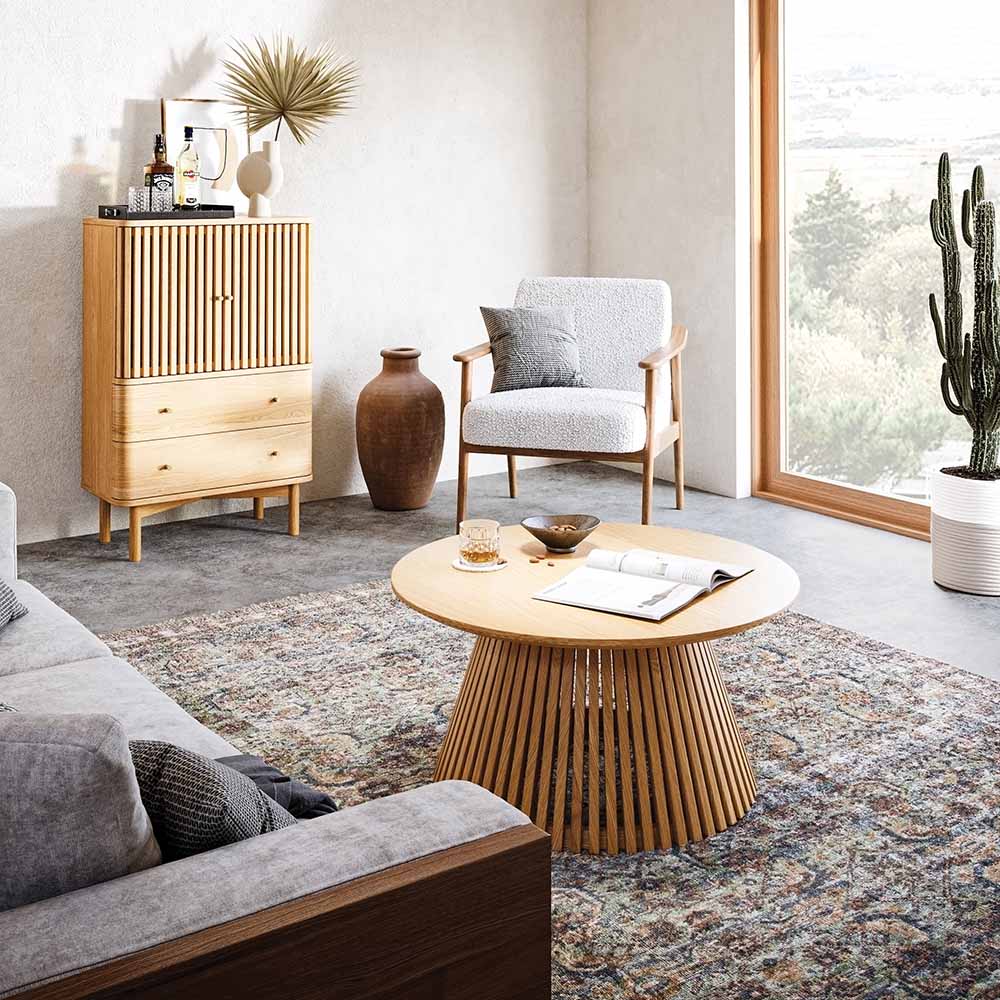 Modern living room with wooden furniture, gray sofa, and decorative items.