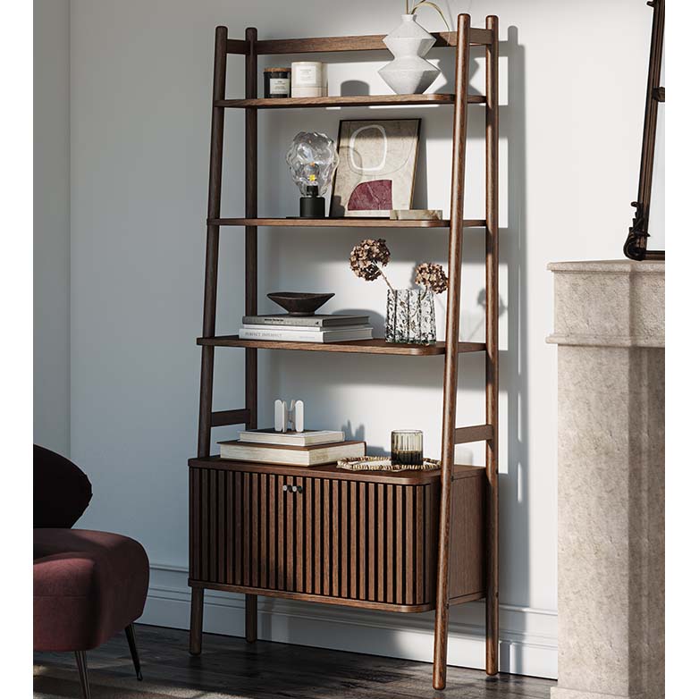 Wooden ladder shelf with decorative items against a white wall.