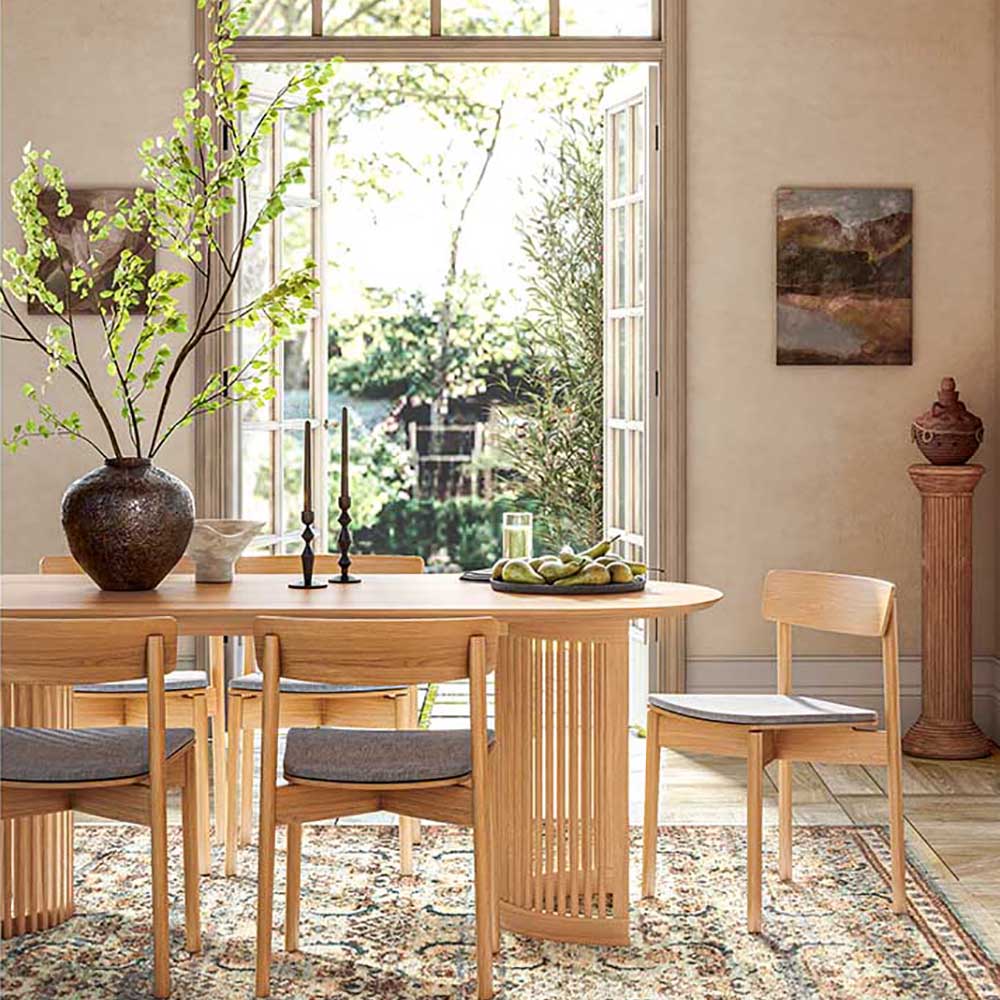 Dining room with wooden table and chairs, large window, and decorative elements.