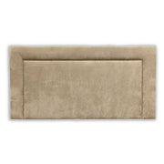 Beige upholstered headboard with a studded metal design on a white background