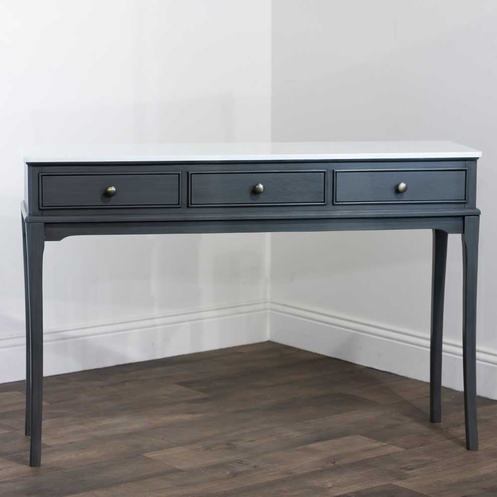 Dark brown coloured console table with three drawers and marble top on a white background