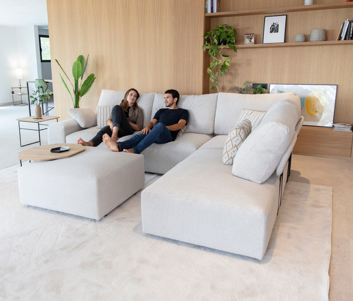 Fama Teseo Corner Sofa with Chaise in Room Setting wit Male and Female Model