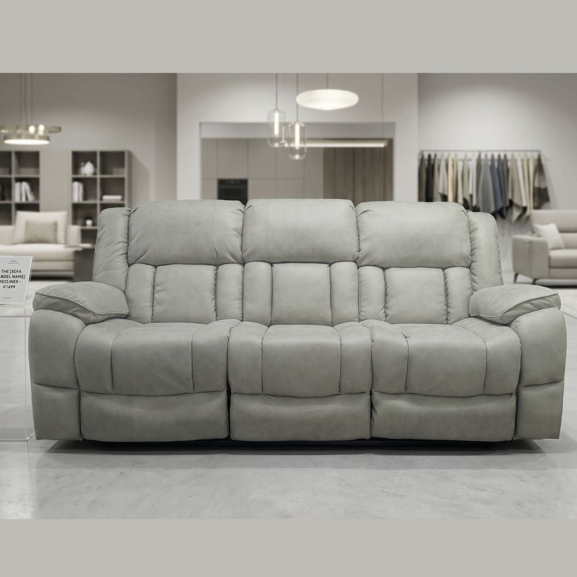 Gray sofa in a showroom setting with clothing racks and shelves in the background.