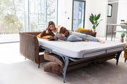 Helsinki Double Sofa Bed by Fama being Lay down on by Model