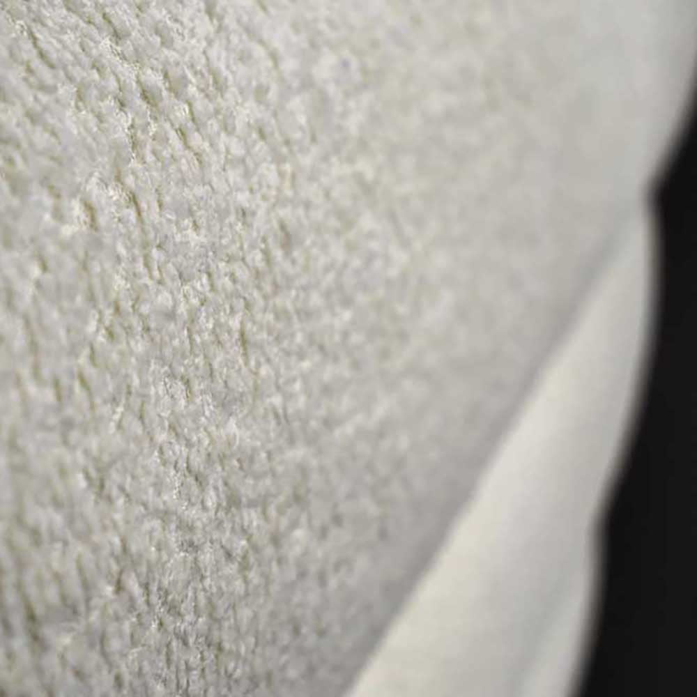 Close-up of textured white surface with a blurred black area