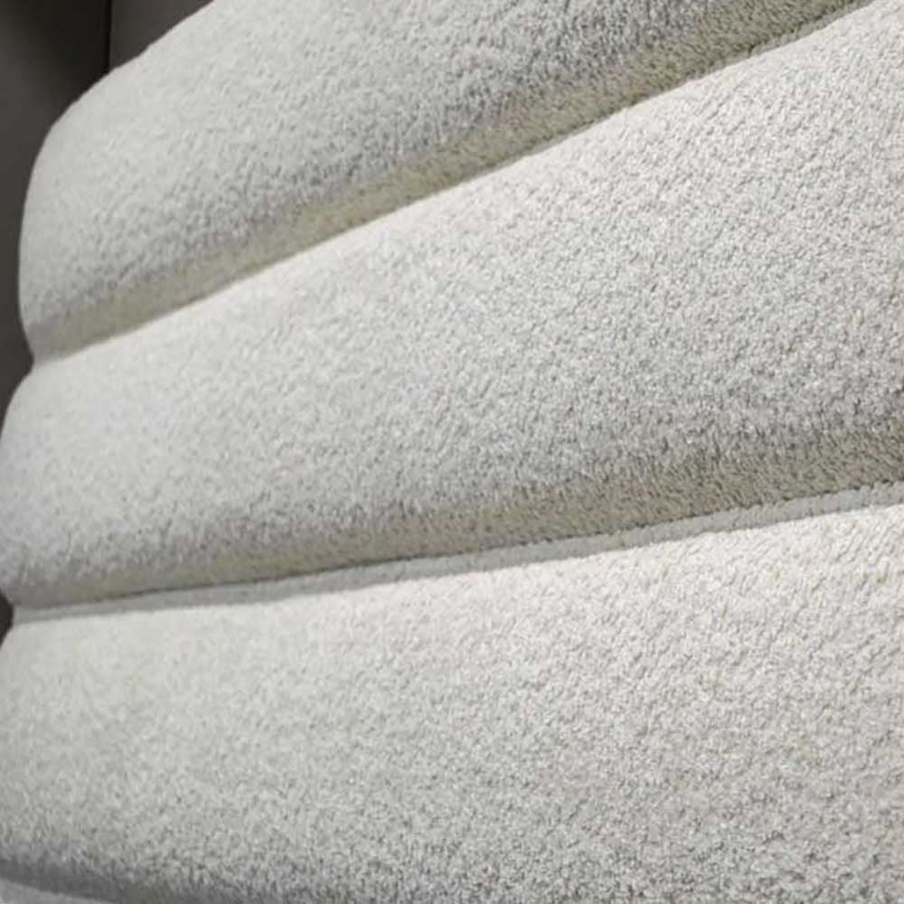 Close-up of textured cream fabric headboard