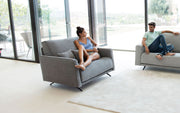 Boston Loveseat by Fama being Sat on by Model