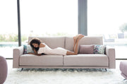 A Model Laying out on the Contemporary and Comfortable Boston Sofa by Fama