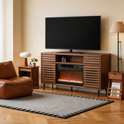 Living room with a wooden TV stand featuring an electric fireplace, television, and decorative items.