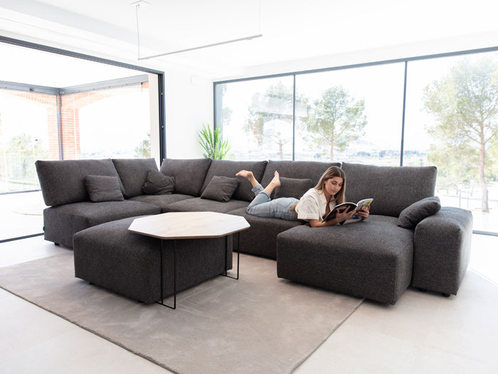 Fama Teseo Corner Sofa with Chaise in Room Setting and model lying down