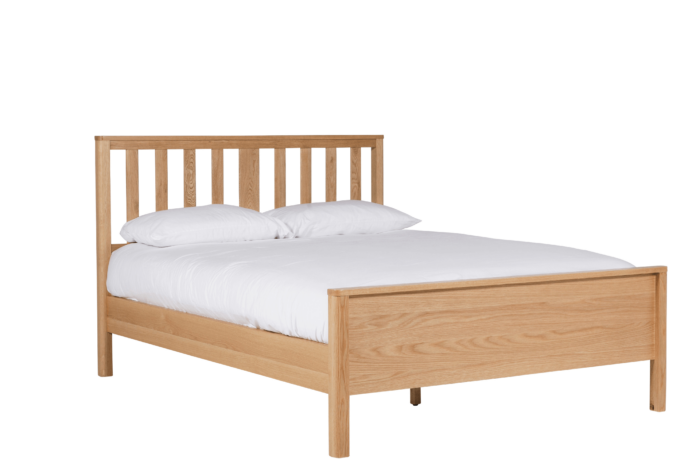 5ft oak bedframe with a low footboard and white bedding for demonstration purposes. mattress nad bedding not included with bedframe.